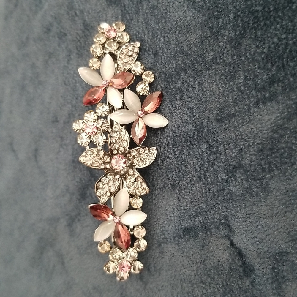 Hair accessory.  Black metal with pink, dark pinkish burgundy with gray crystals